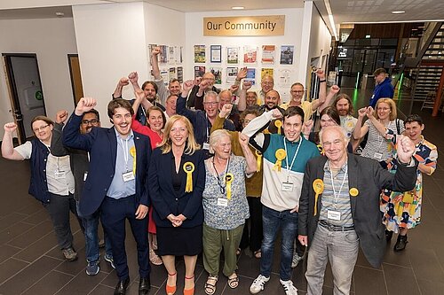 Liz's celebrating an election win with a group of supporters